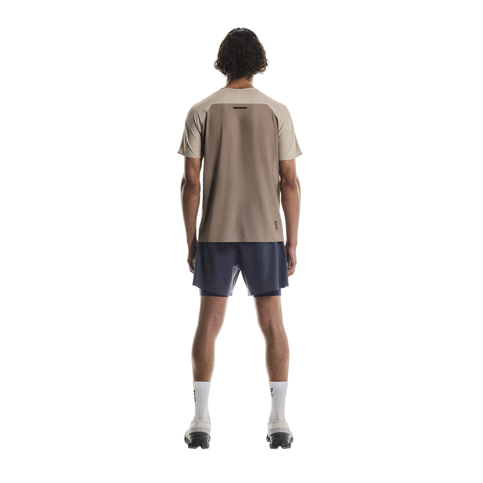 Back view of a model wearing the On Men's Performance-T in the Desert/Cinder colourway.