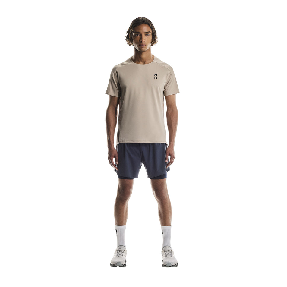 Front view of a model wearing the On Men's Performance-T in the Desert/Cinder colourway.