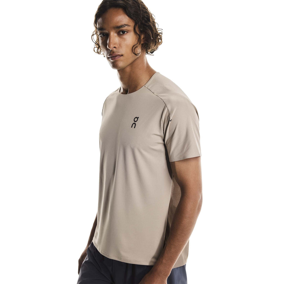 Front view of a model wearing the On Men's Performance-T in the Desert/Cinder colourway.