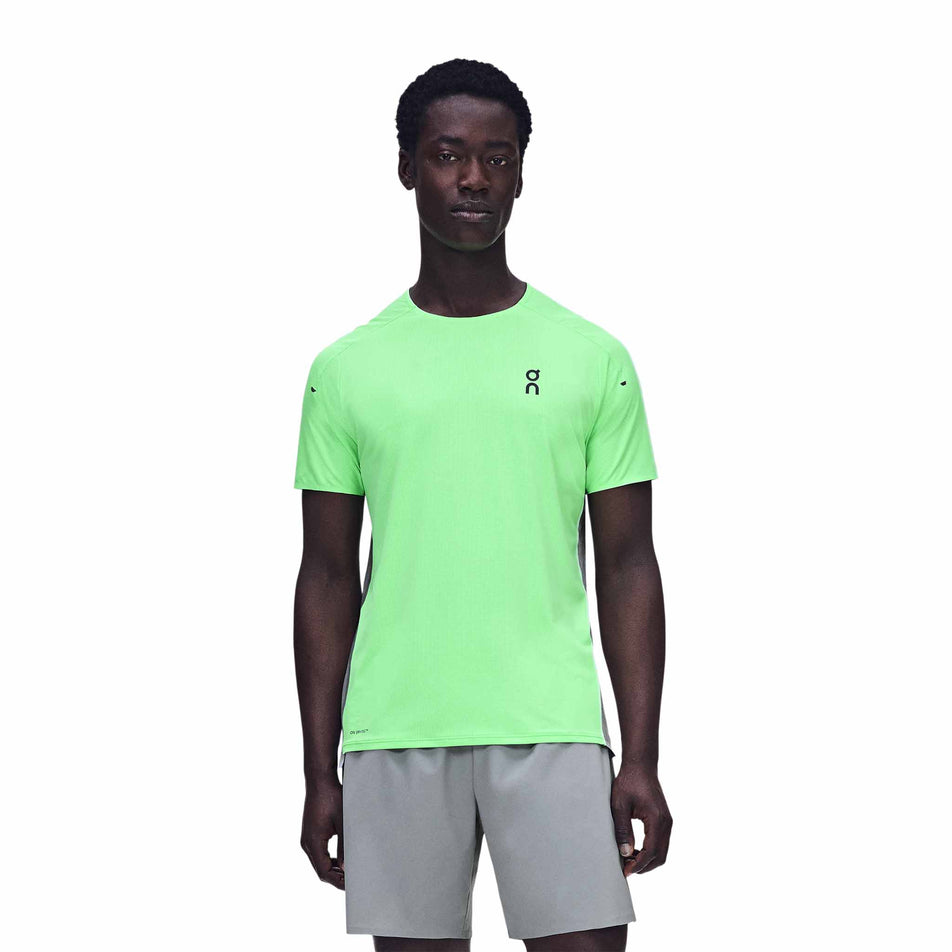 Front view of a model wearing the On Men's Performance-T in the Verdite/Apollo colourway.