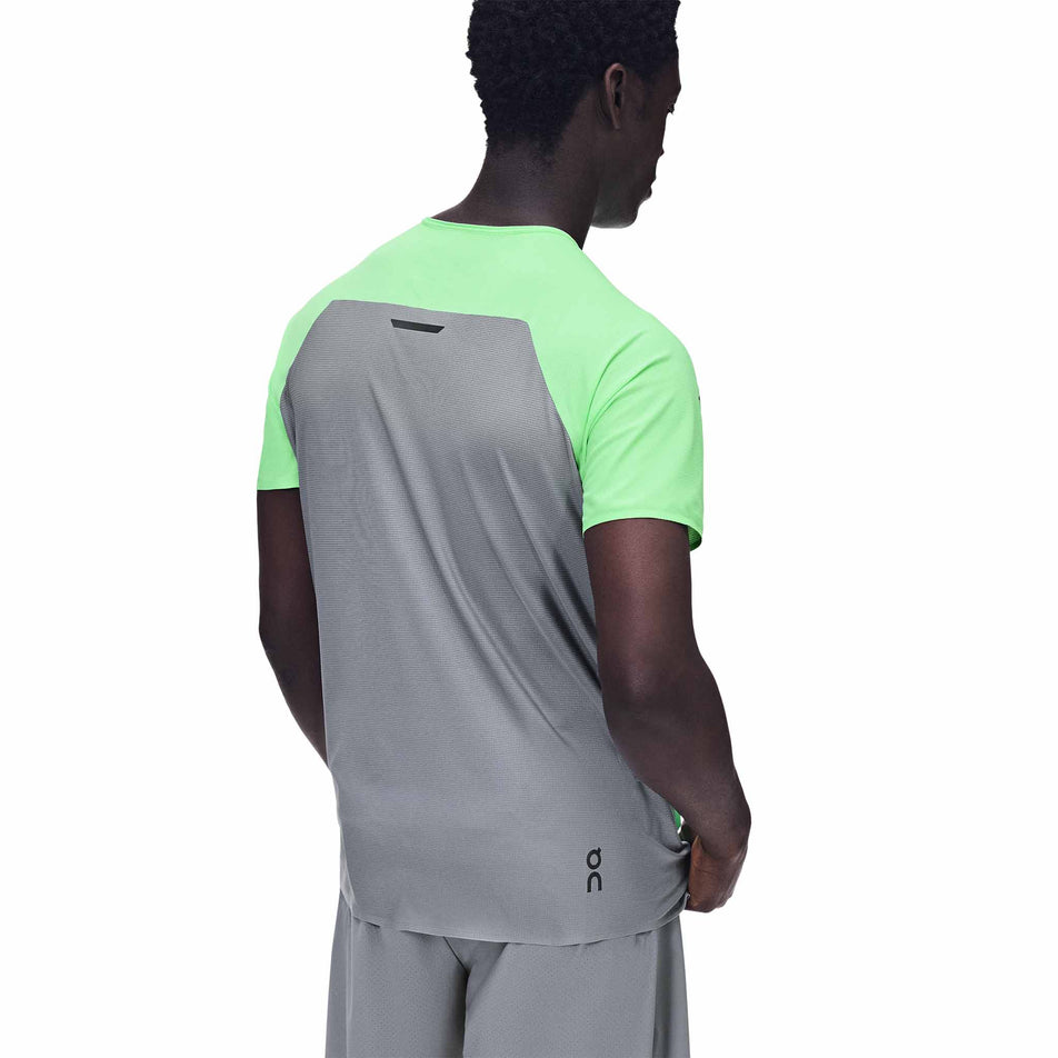Back view of a model wearing the On Men's Performance-T in the Verdite/Apollo colourway.