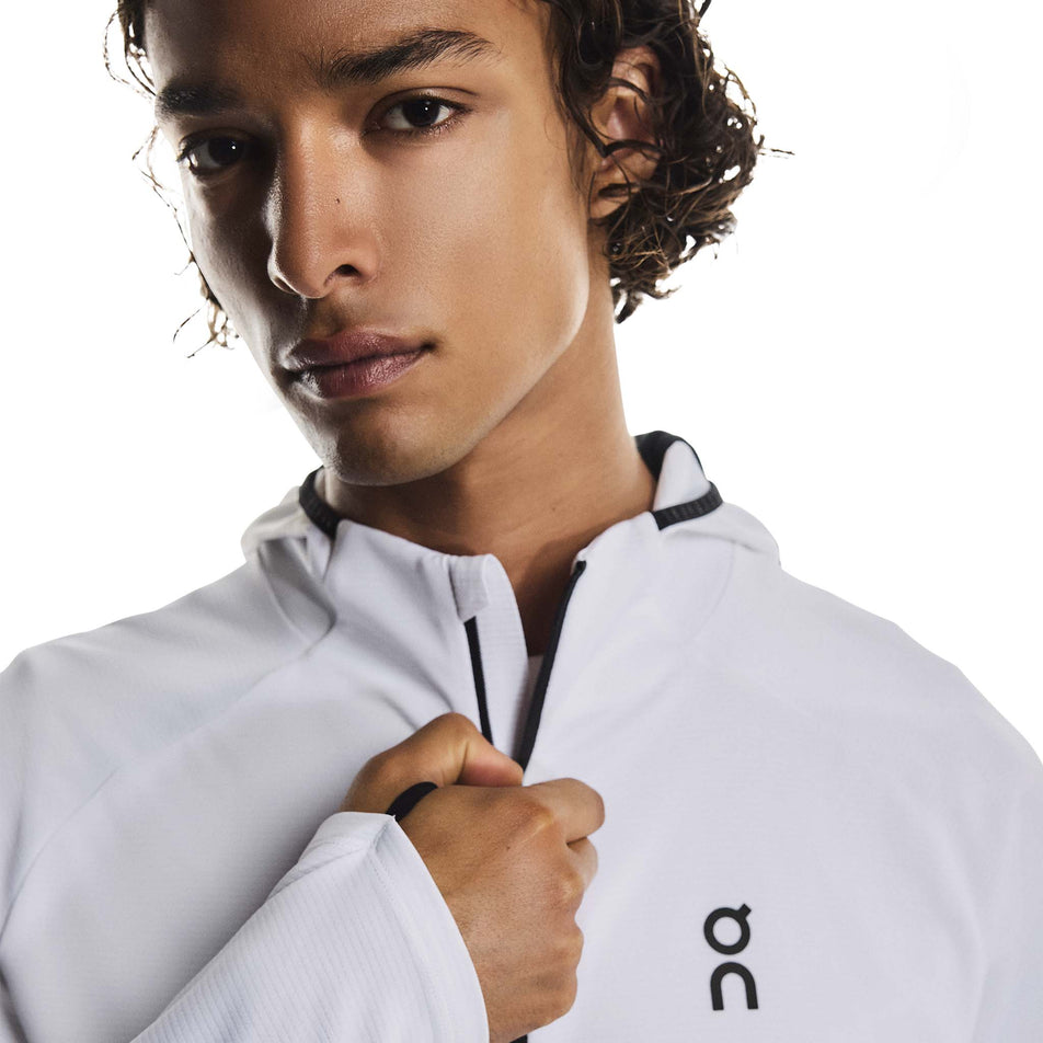 Front view of a model wearing the On Men's Climate Zip Hoodie in the White colourway.