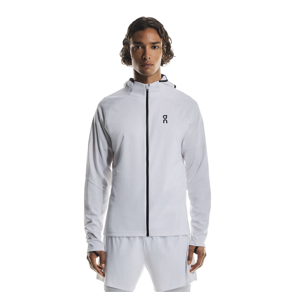 Front view of a model wearing the On Men's Climate Zip Hoodie in the White colourway.