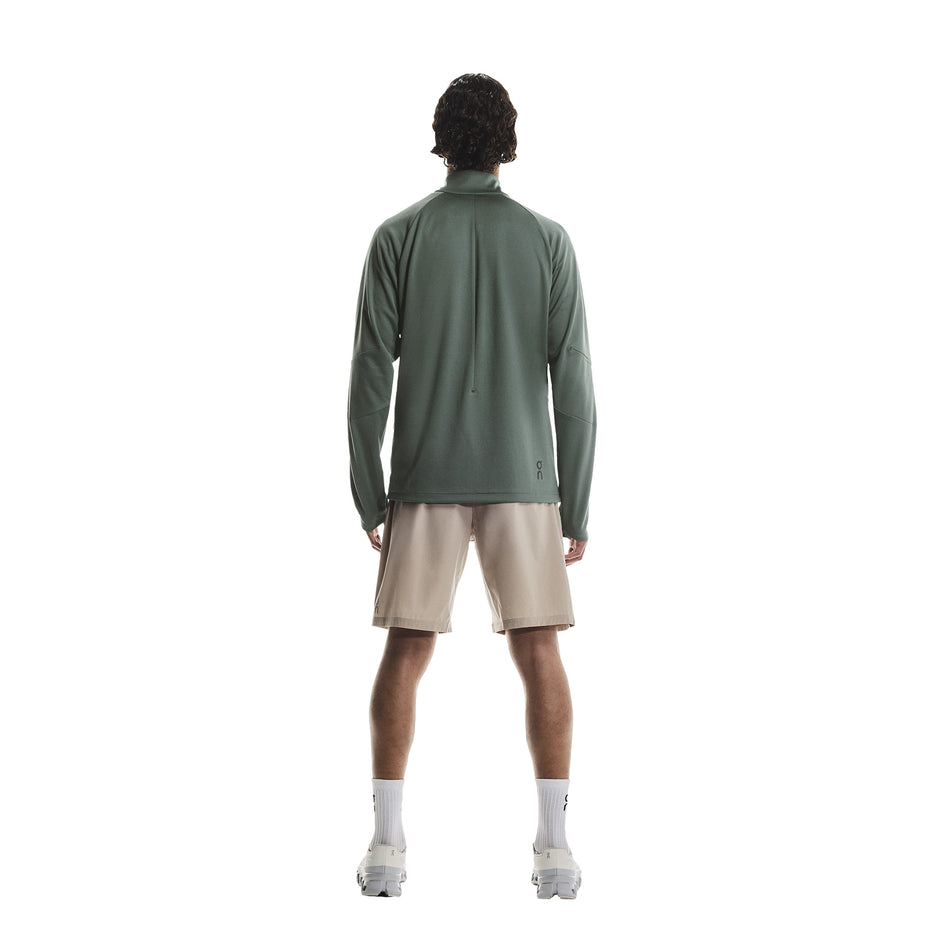 Back view of a model wearing the On Men's Climate Shirt in the Olive colourway. (8790094643362)