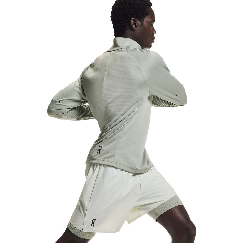 Angled view of a model wearing the On Men's Climate Shirt in the Tin colourway.