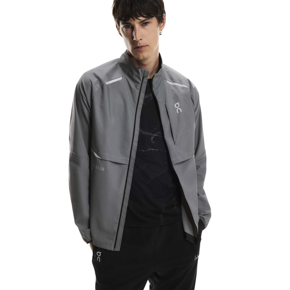 Front view of a model wearing the On Men's Weather Jacket Lumos in the Eclipse colourway. (8790125510818)