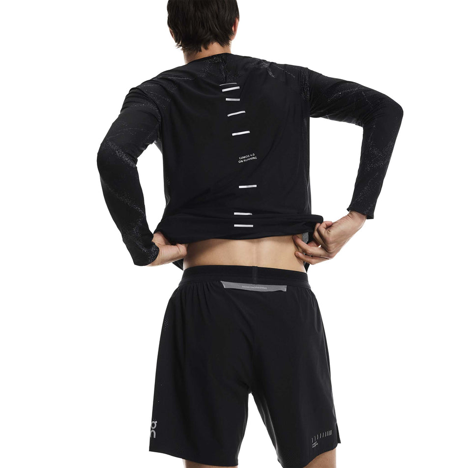 Back view of a model wearing the On Men's Performance Shorts Lumos in the Eclipse/Black colourway. (8790133473442)