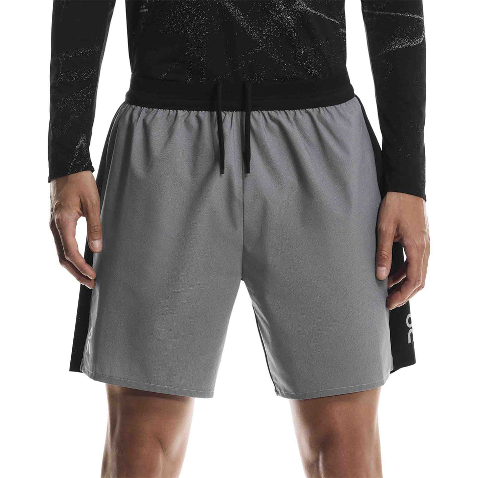 Front view of a model wearing the On Men's Performance Shorts Lumos in the Eclipse/Black colourway. (8790133473442)