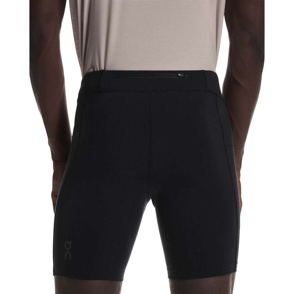 Back view of a model wearing the On Men's 8