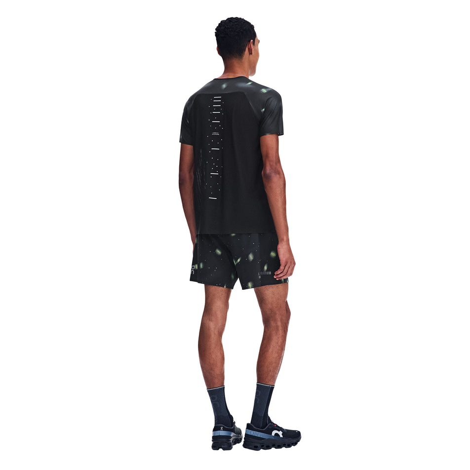 Back view of a model wearing the On Men's Performance-T Lumos 2.0 in the Black colourway.