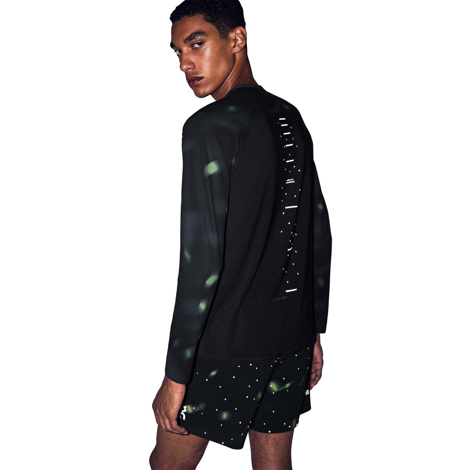 Back view of a model wearing the On Men's Performance Long-T Lumos 3.0 in the Black colourway.