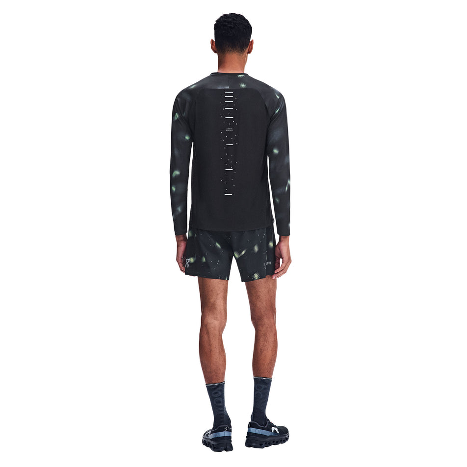 Back view of a model wearing the On Men's Performance Long-T Lumos 3.0 in the Black colourway.