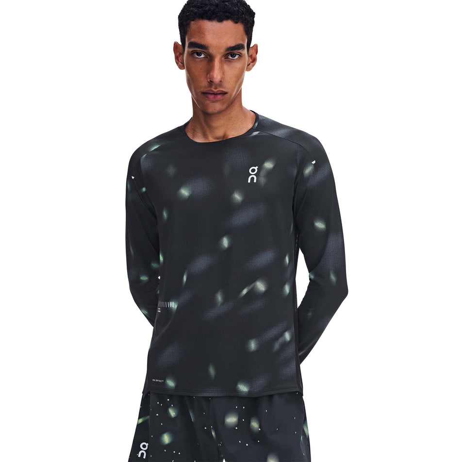 Front view of a model wearing the On Men's Performance Long-T Lumos 3.0 in the Black colourway.