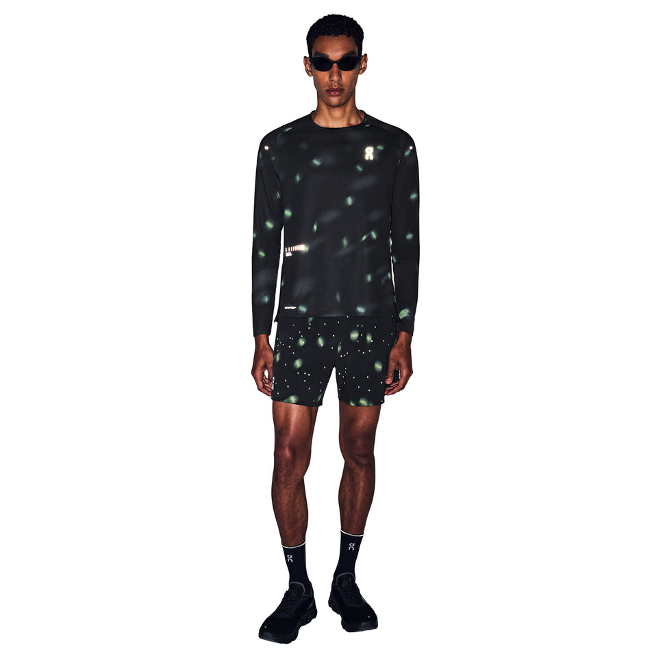 Front view of a model wearing the On Men's Performance Long-T Lumos 3.0 in the Black colourway.