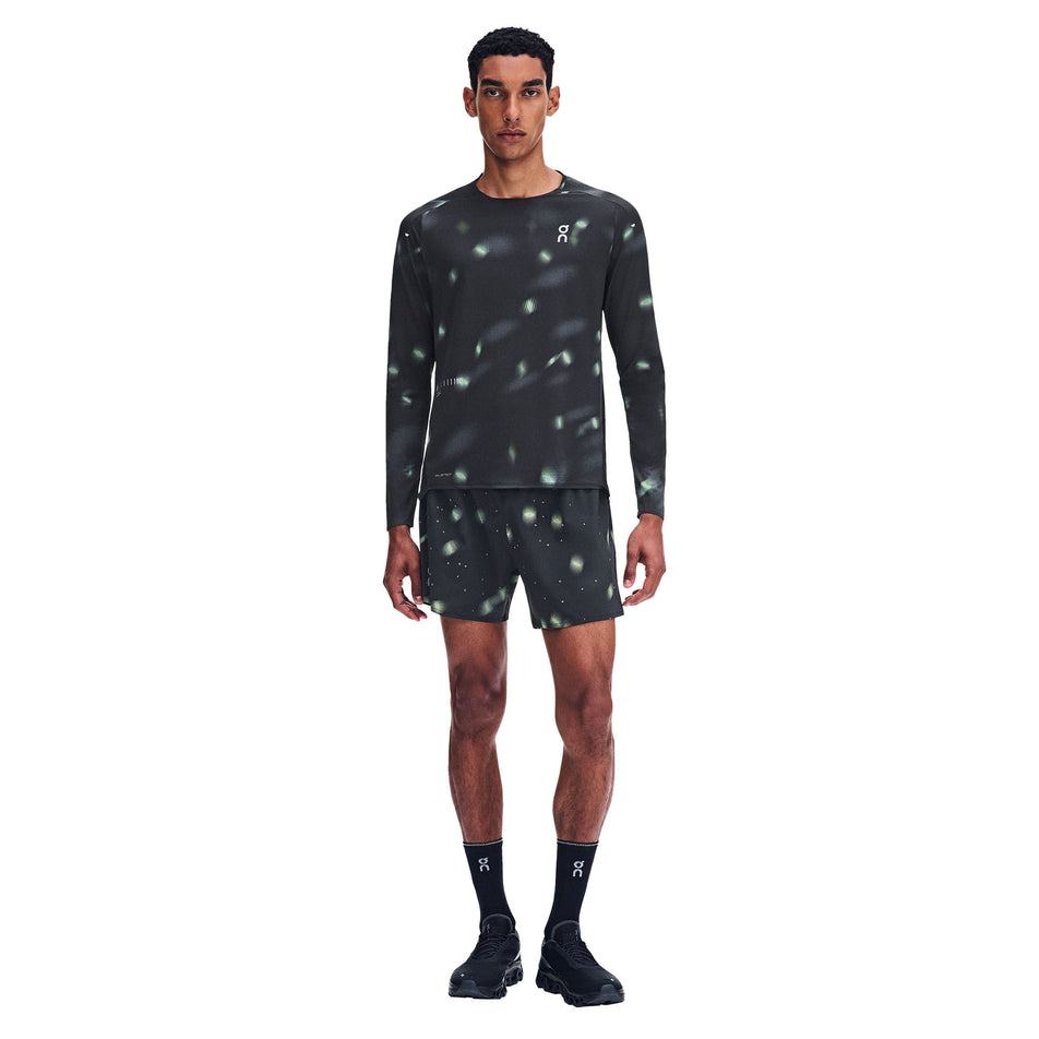 Front view of a model wearing the On Men's Performance Long-T Lumos 3.0 in the Black colourway.
