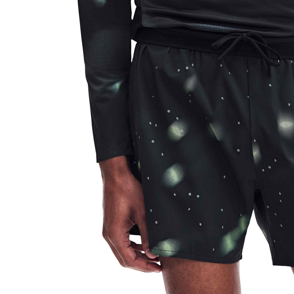 Front view of a model wearing the On Men's Performance Shorts Lumos 2.0 in the Black colourway.