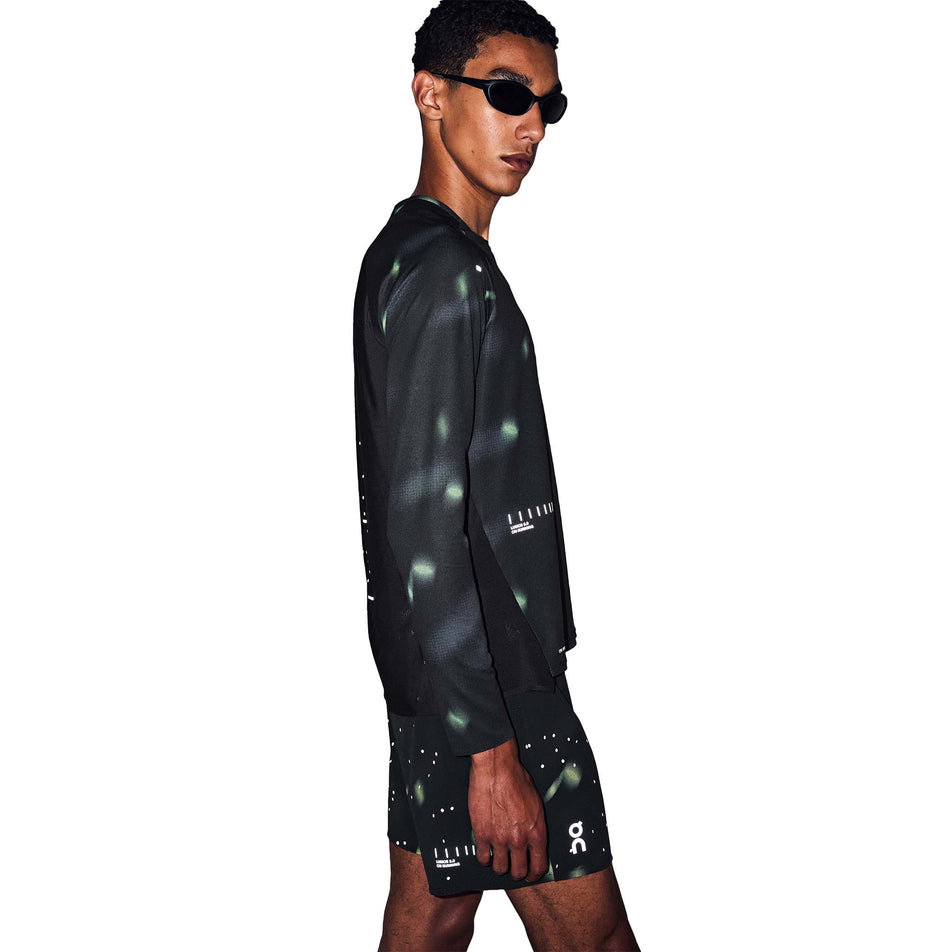 Side view of a model wearing the On Men's Performance Shorts Lumos 2.0 in the Black colourway.