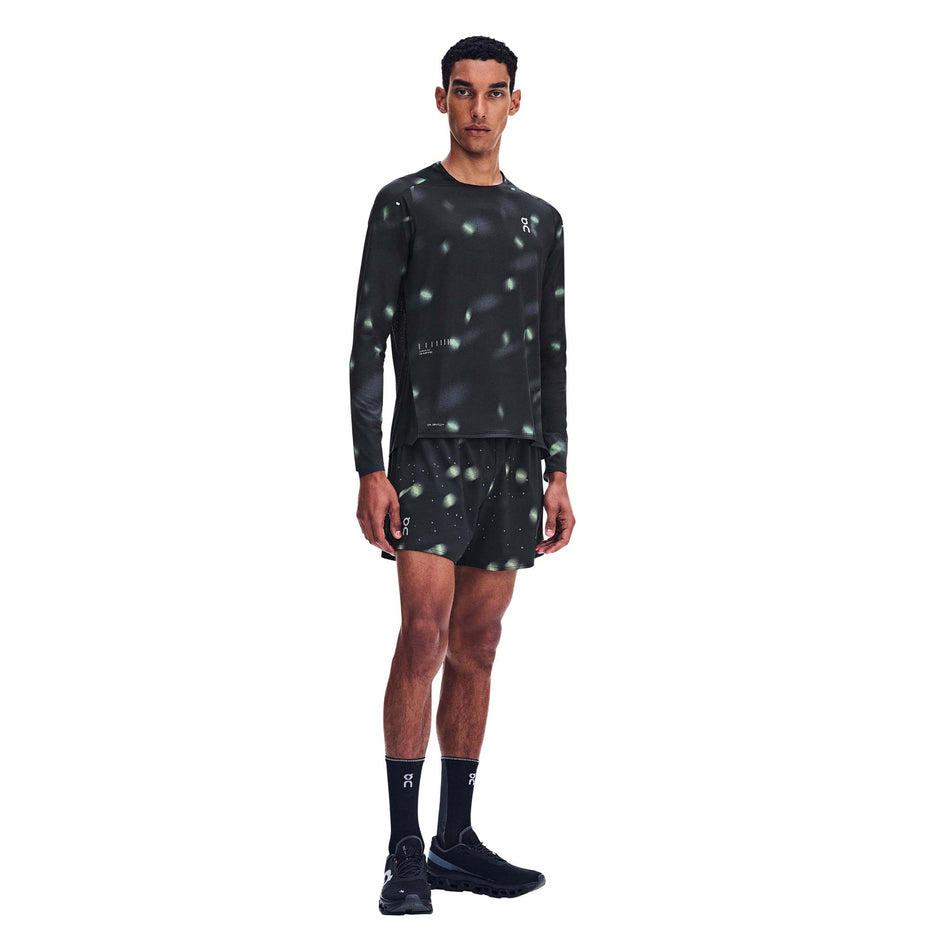 Front view of a model wearing the On Men's Performance Shorts Lumos 2.0 in the Black colourway.