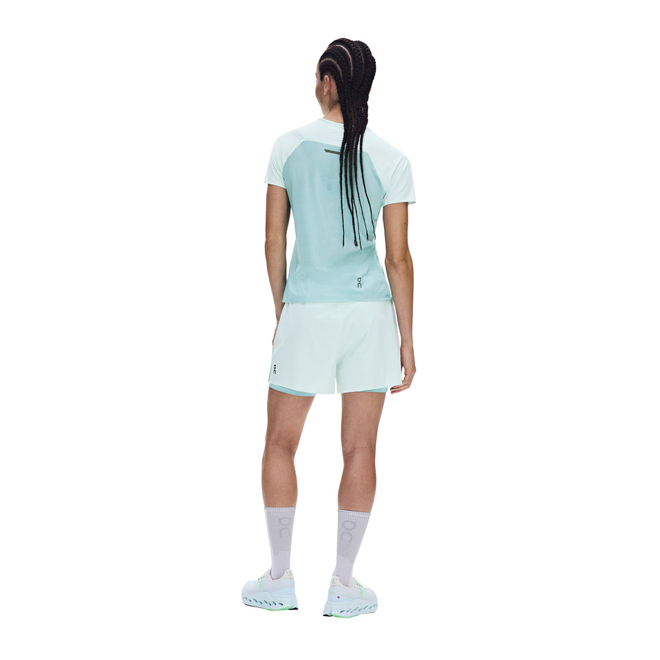 Back view of a model wearing the On Women's Performance-T in the Flurry/Aquamarine colourway.