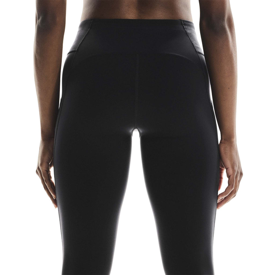 Back view of a model wearing the On Women's Performance Tights in the Black colourway.