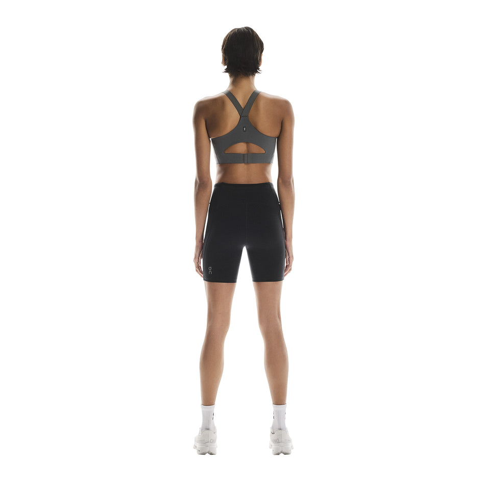 Back view of a model wearing the On Women's Performance Tights Short in the Black colourway. (8715718197410)