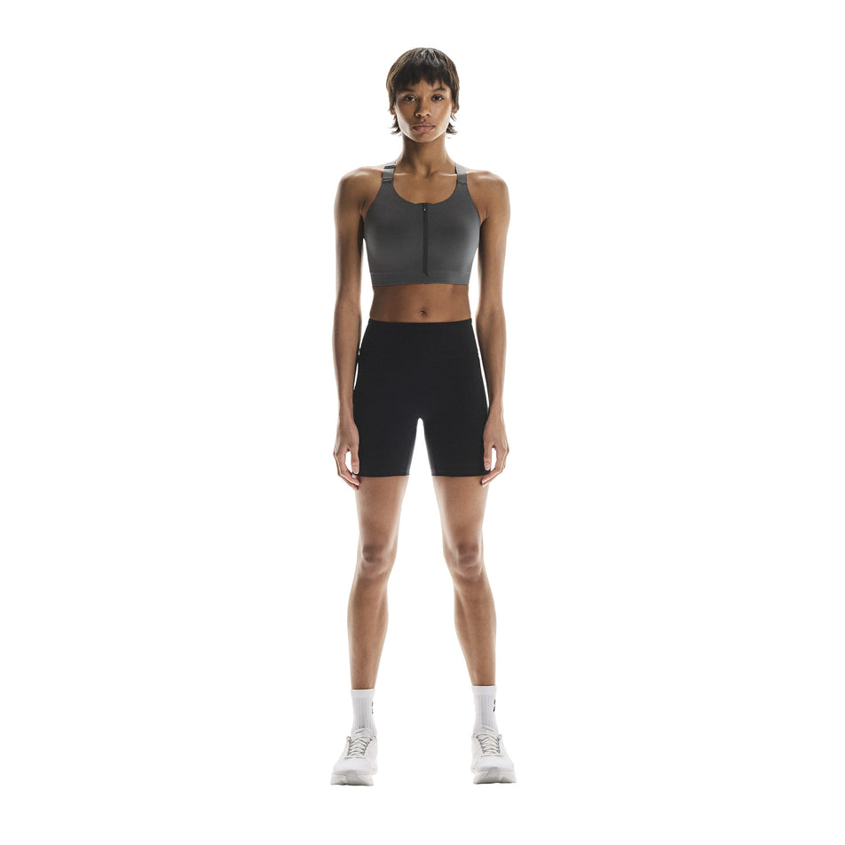 Front view of a model wearing the On Women's Performance Tights Short in the Black colourway. (8715718197410)