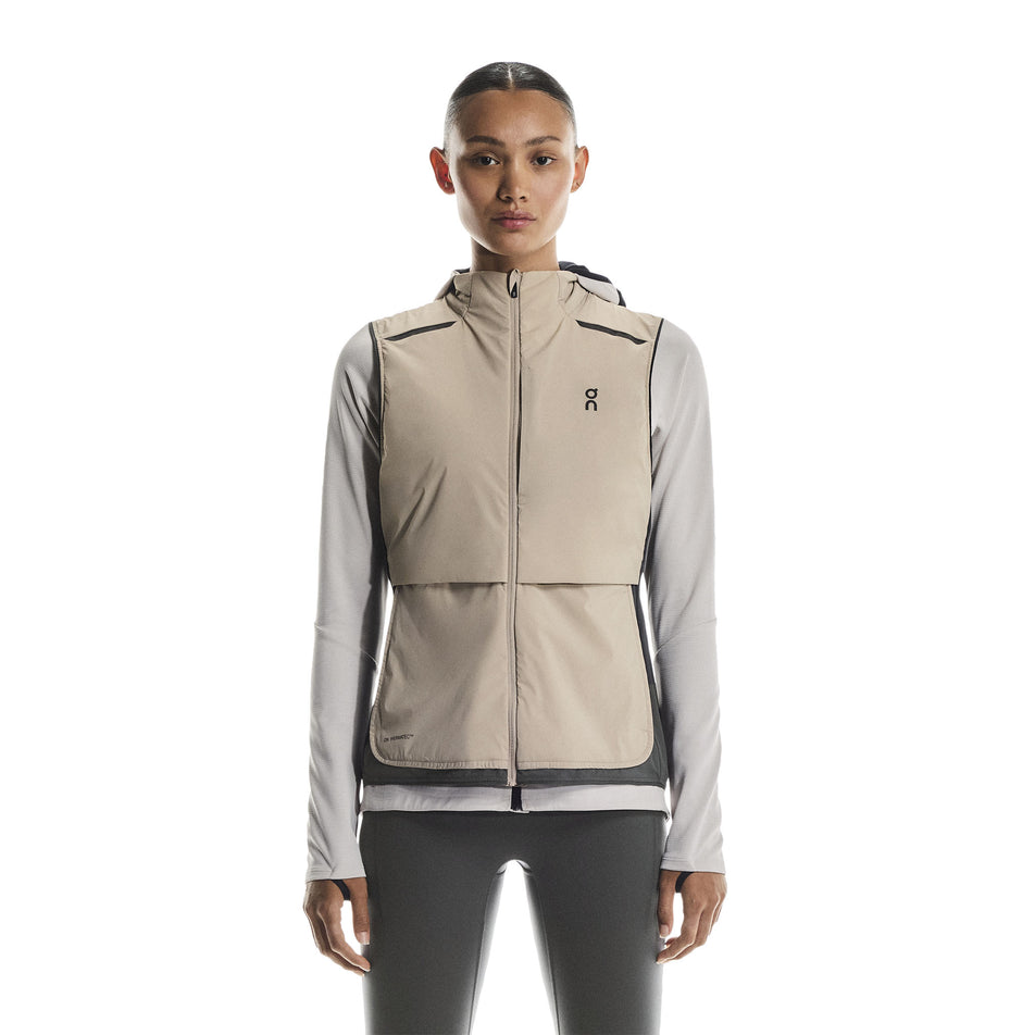 Front view of a model wearing the On Women's Weather Vest in the Desert/Eclipse colourway. (8790011412642)