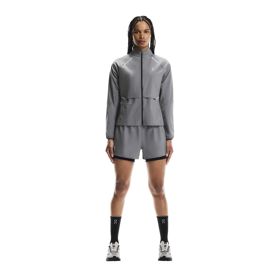 Front view of a model wearing the On Women's Weather Jacket Lumos in the Eclipse colourway. (8790034808994)