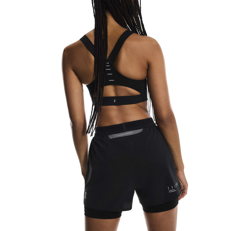 Back view of a model wearing the On Women's Performance Shorts Lumos in the Eclipse/Black colourway. (8790051815586)