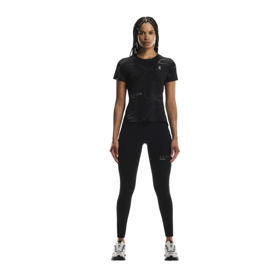 Front view of a model wearing the On Women's Performance Tights Lumos in the Black colourway. (8790043394210)
