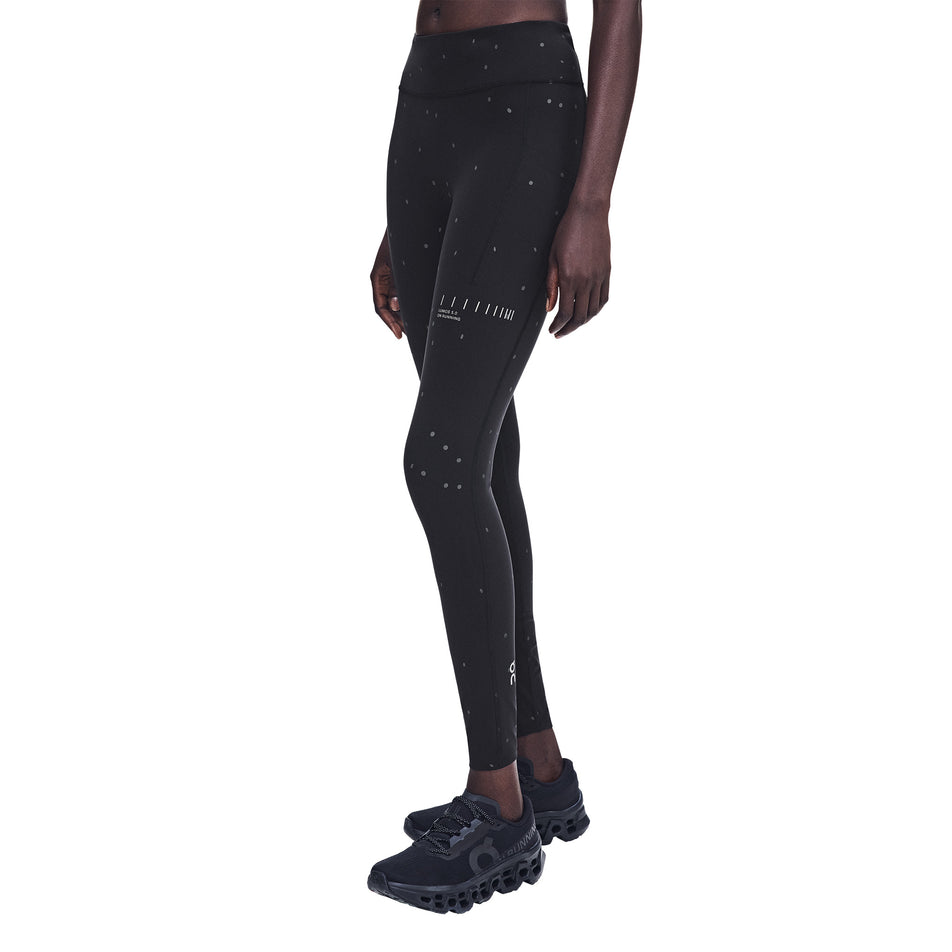 Front view of a model wearing the On Women's Performance Tights Lumos 2.0 in the Black/Eclipse colourway.