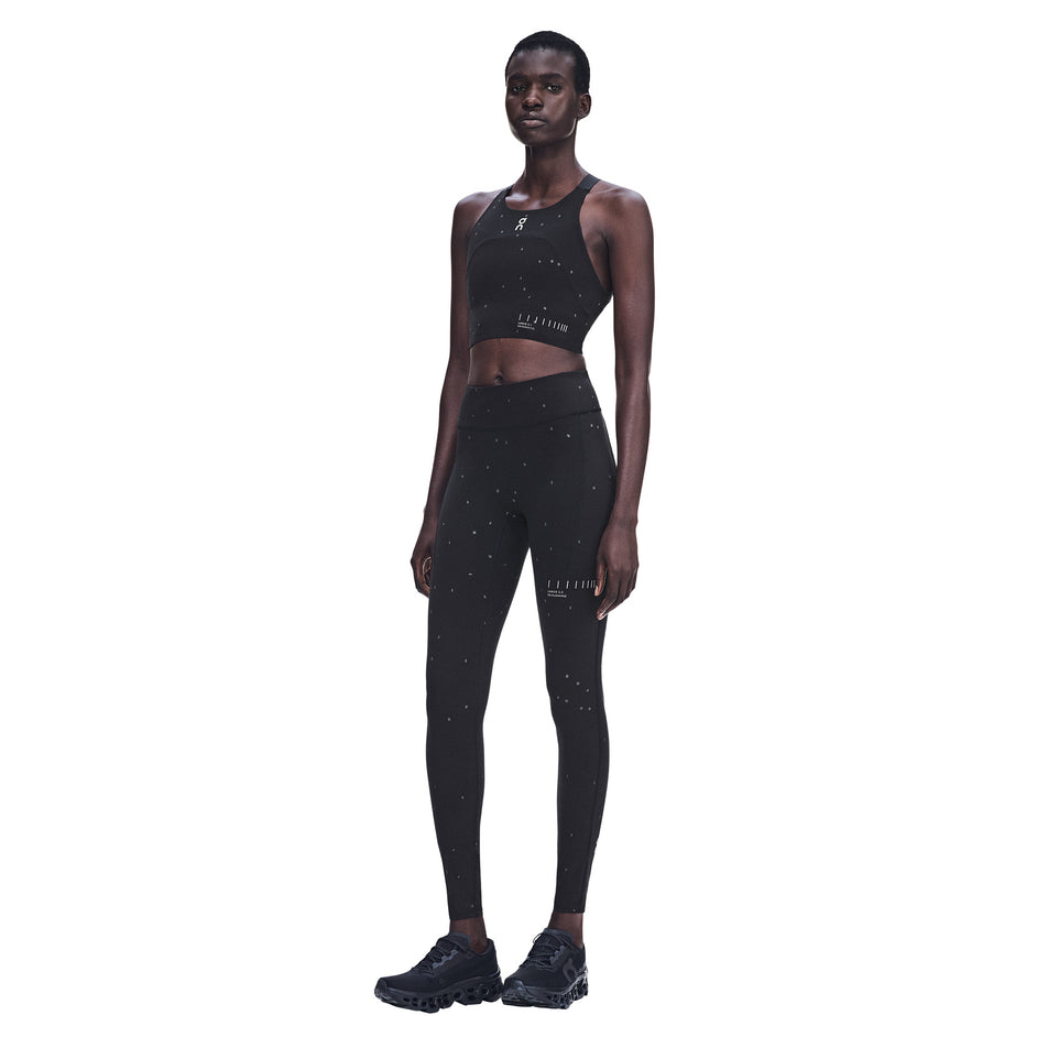 Front view of a model wearing the On Women's Performance Tights Lumos 2.0 in the Black/Eclipse colourway.