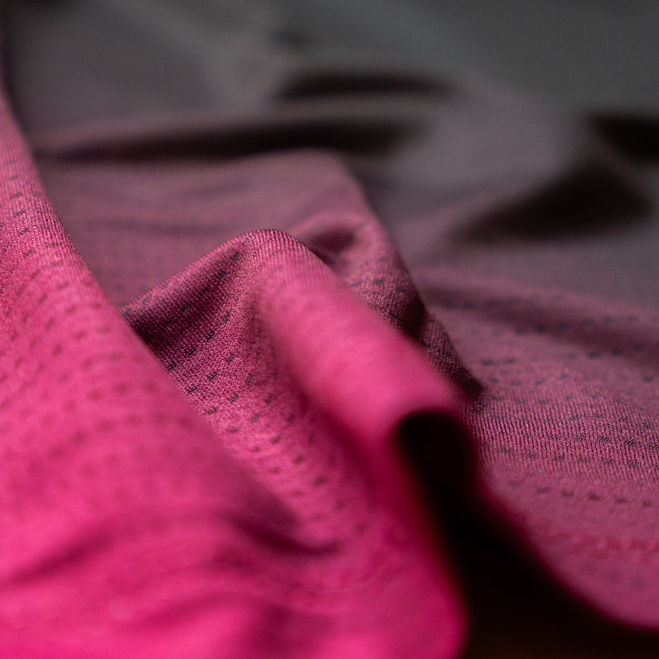 Close-up view of the fabric on the EMF Official Licensed Merchandise | Pressio Women's Prevail Singlet in the Black/Pink colourway.