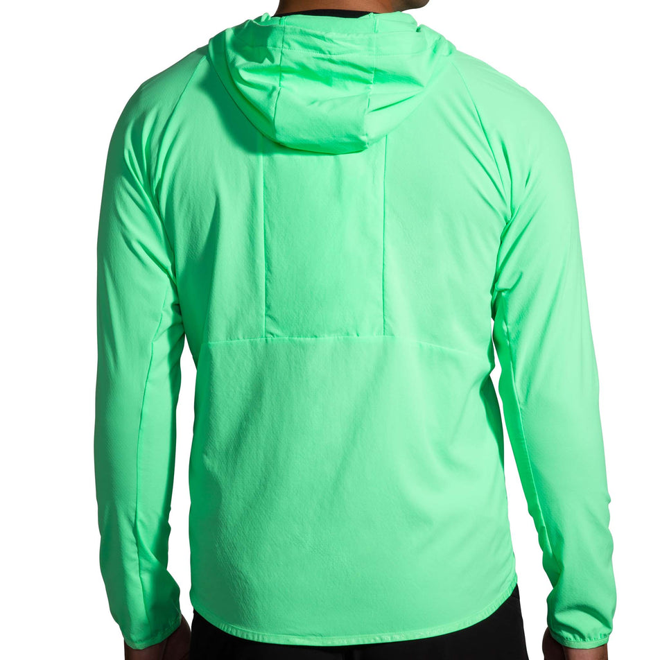 Back view of a model wearing a Brooks Canopy Running Jacket in the Neo Green colourway (8007418314914)