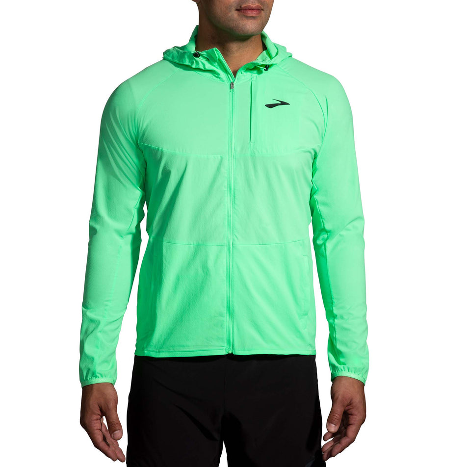 Front view of a model wearing a Brooks Canopy Running Jacket in the Neo Green colourway (8007418314914)