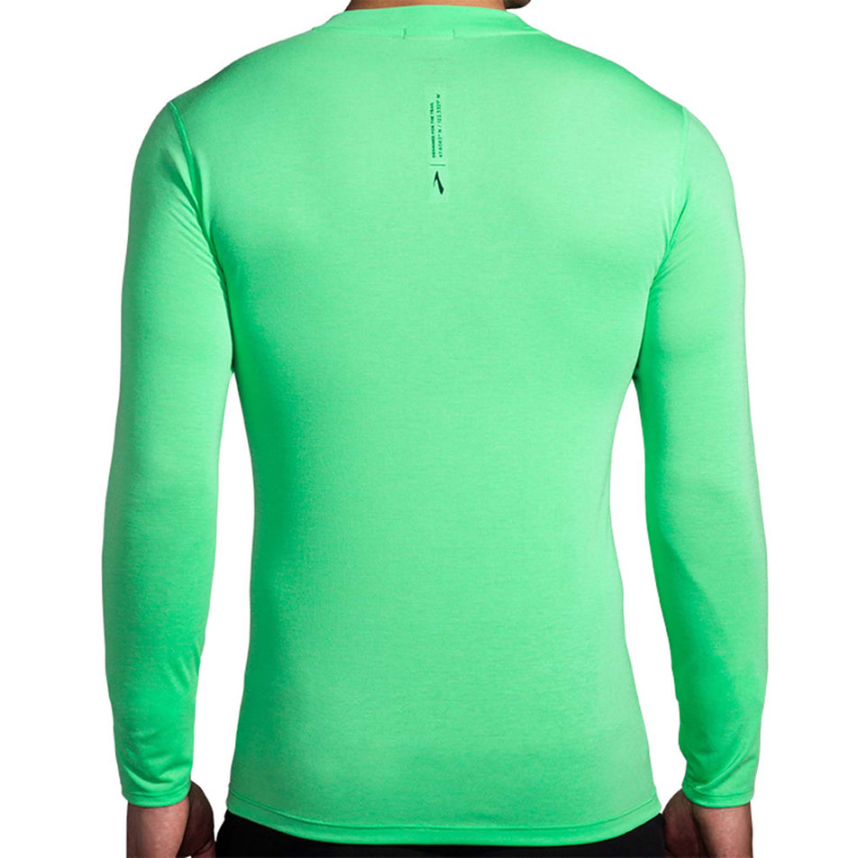 Back view of a model wearing a Brooks Men's High Point Long Sleeve Top in the Hyper Green colourway. Model is also wearing Brooks legwear. (8177411260578)