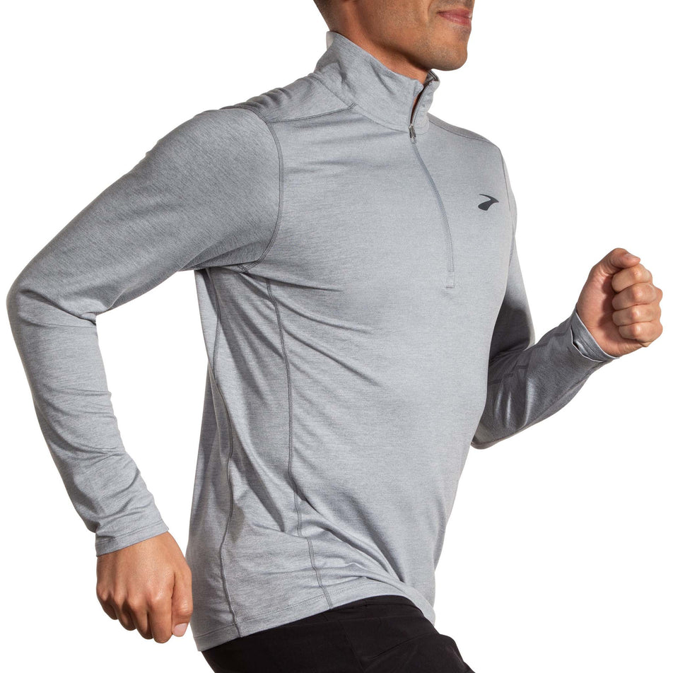 Angled front view of a model wearing a Brooks Men's Dash 1/2 Zip 2.0 in the Heather Stone colourway. (8177451729058)