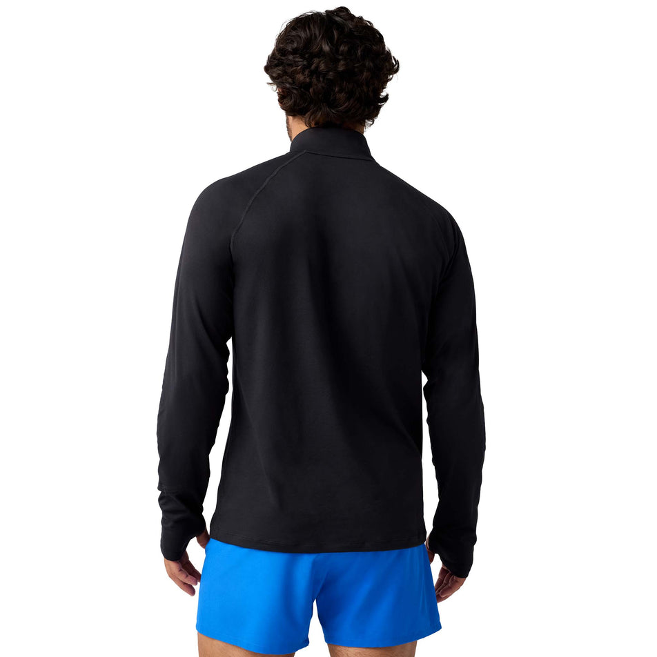 Back view of a model wearing the Brooks Men's Dash 1/4 Zip 3.0 in the Black colourway.