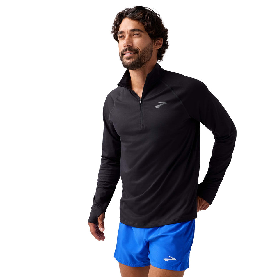 Front view of a model wearing the Brooks Men's Dash 1/4 Zip 3.0 in the Black colourway.