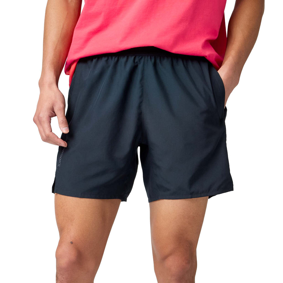 Front view of a model wearing the Brooks Men's Dash Shorts in the Black colourway.