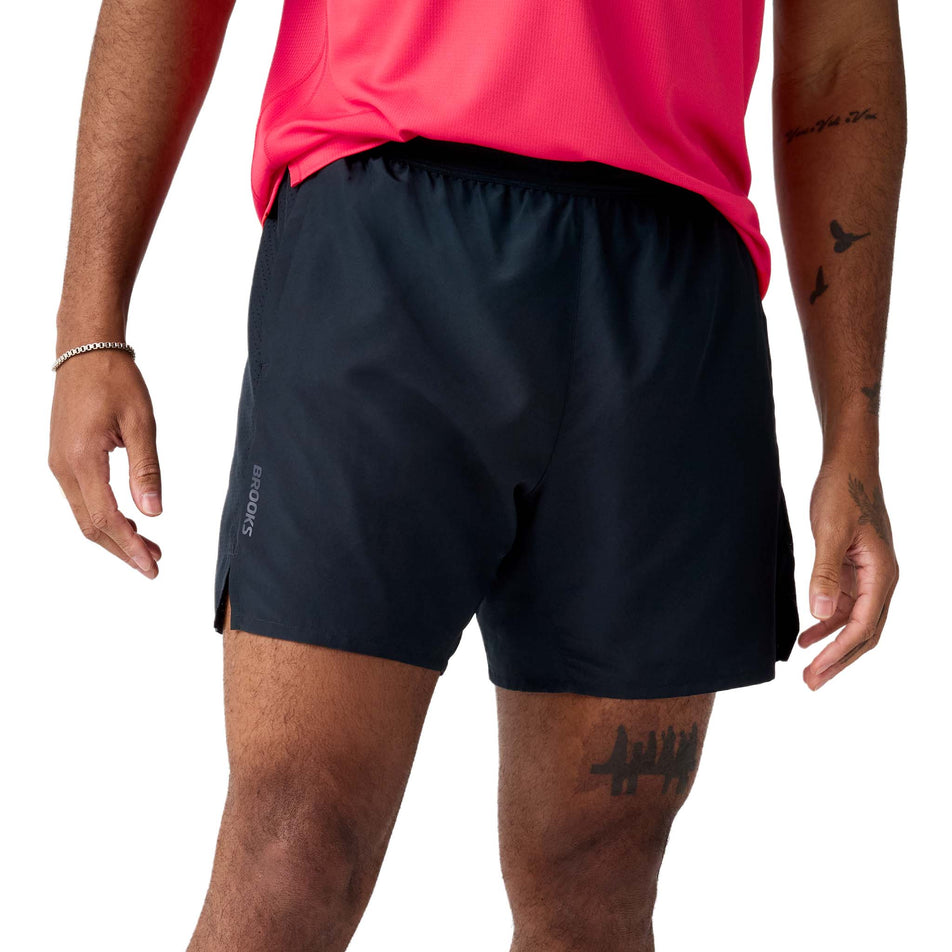 Front view of a model wearing the Brooks Men's Dash 2-in-1 Shorts in the Black colourway.