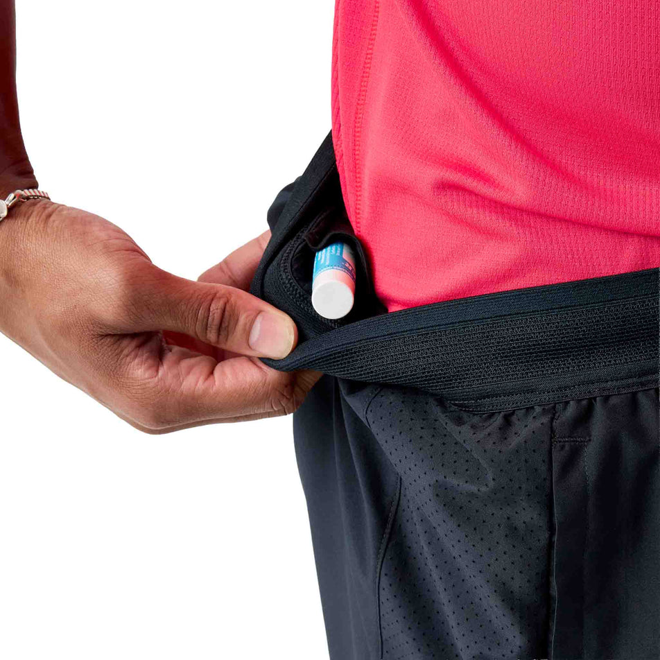 The drop-in (no zip) pocket on the inner waistband of the Brooks Men's Dash 2-in-1 Shorts in the Black colourway.