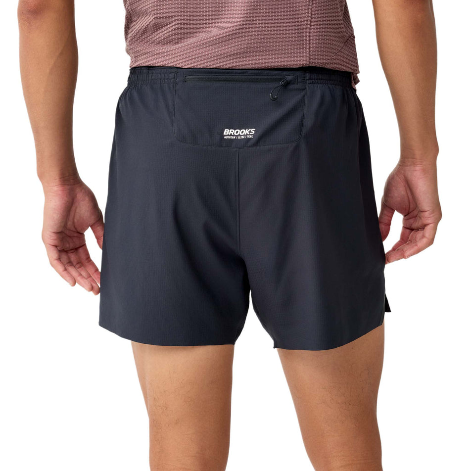 Back view a model wearing the Brooks Men's Cascadia 2-In-1 Short in the Black colourway.