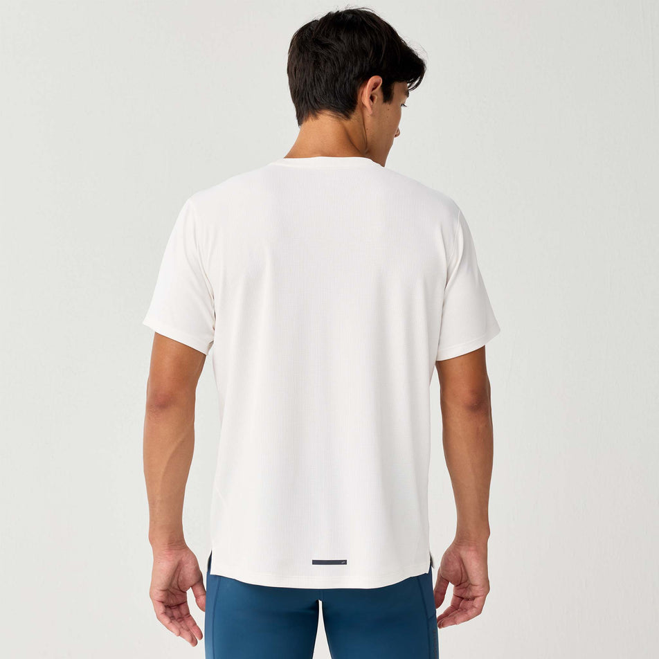 Back view of a model wearing the Brooks Men's Dash Reflective Short Sleeve in the Bone/Reflective colourway.