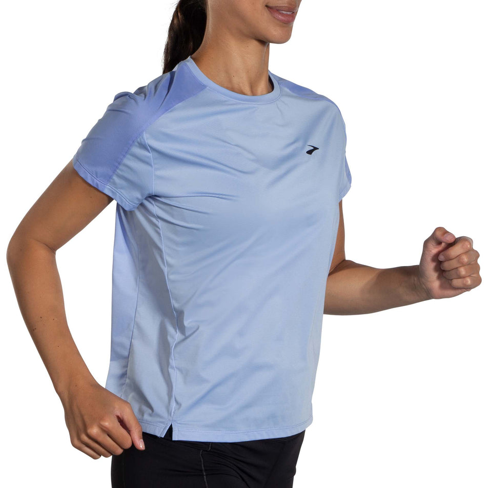 Front view of a model wearing a Brooks Women's Sprint Free Short Sleeve 2.0 T-Shirt in the Lt Lavender/Blue Lavender colourway. Model is in a running pose. (8007498858658)