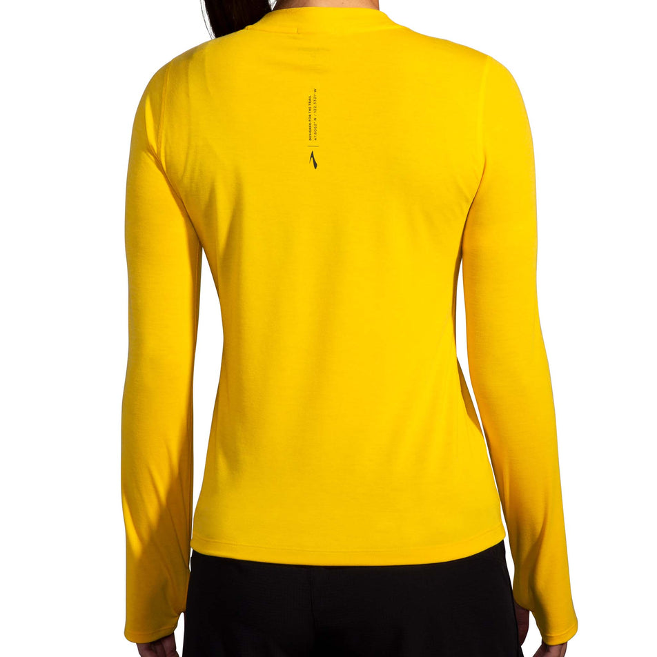 Back view of a model wearing a Brooks Women's High Point Long Sleeve Top in the Lemon Chrome colourway. Model is also wearing Brooks legwear. (8177458249890)