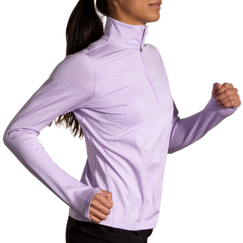 Side view of a model wearing a Women's Dash 1/2 Zip 2.0 in the Heather Purple colourway. Model is also wearing Brooks legwear. (8177476665506)
