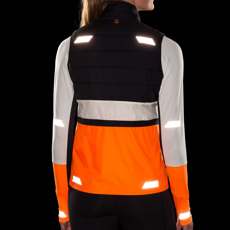 The reflective details on the back of the Brooks Women's Run Visible Insulated Vest 2.0 in the Ecru/Fluoro Flash/Black colourway. (8778453483682)