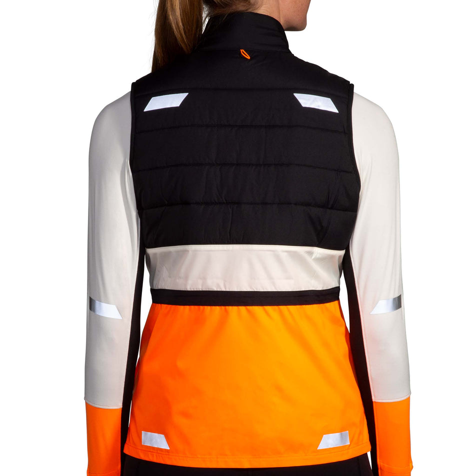 Back view of a model wearing the Brooks Women's Run Visible Insulated Vest 2.0 in the Ecru/Fluoro Flash/Black colourway. (8778453483682)