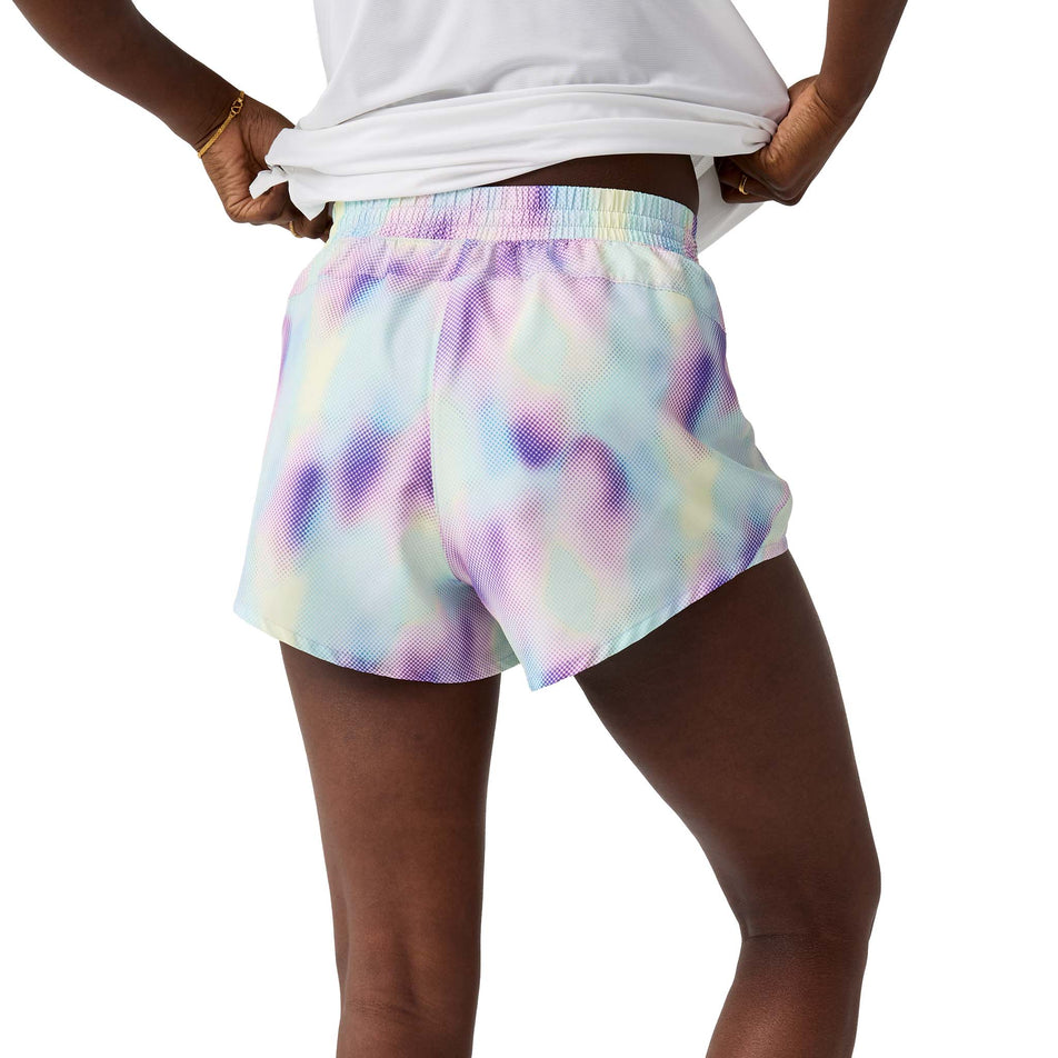 Back view of a model wearing the Brooks Women's Dash Short in the Euphoryc Halogen colourway.